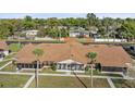 An aerial view of a villa with a cozy screened-in porch and manicured front lawn at 1001 Plantation Dr # D5, Kissimmee, FL 34741