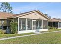 Charming villa with a cozy screened-in porch and manicured front lawn at 1001 Plantation Dr # D5, Kissimmee, FL 34741