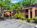 A lush landscaped condo community showing well-maintained buildings, landscaping and ample parking at 1068 E Michigan St # A, Orlando, FL 32806