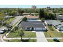 Aerial view of a well-maintained single-story home with a green lawn and long driveway at 11364 Cardiff Dr, Orlando, FL 32837