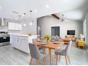 Open-concept living room with a modern kitchen island and vaulted ceiling at 11364 Cardiff Dr, Orlando, FL 32837