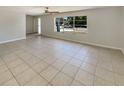 Spacious living area featuring tile floors and a large window bringing in lots of natural light at 1155 Galahad Dr, Casselberry, FL 32707