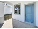 The front door is blue with white trim and a window near the entrance at 13820 Adams St, Grand Island, FL 32735