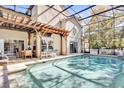 Inviting screened-in pool area with a covered pergola, ample seating, and access to the home at 14266 Squirrel Run, Orlando, FL 32828