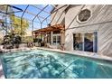 Screened-in pool area featuring a covered patio with stylish outdoor furniture, perfect for relaxation at 14266 Squirrel Run, Orlando, FL 32828
