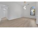 Bright living room with hardwood floors, a large window, and modern light fixture at 1510 Wescott Loop, Winter Springs, FL 32708