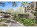 This shot shows an exterior view of the home, parking, and beautifully landscaped grounds at 1570 Farrindon Cir, Lake Mary, FL 32746