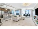 Bright living room and kitchen open concept with marble floors, chandeliers and serene water views at 16300 County Road 455 # 401, Montverde, FL 34756