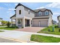 Attractive two-story house showcasing a two-car garage and manicured front lawn at 16354 Silver Grove Blvd, Winter Garden, FL 34787