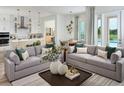Open-concept living space with modern decor connecting to the kitchen, dining area, and pool views at 16354 Silver Grove Blvd, Winter Garden, FL 34787