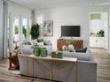 Bright living room with contemporary furnishings, neutral colors, wood floors, and lots of natural light at 16354 Silver Grove Blvd, Winter Garden, FL 34787