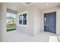 Inviting covered porch with a window and a blue front door at 16354 Silver Grove Blvd, Winter Garden, FL 34787