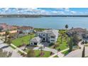 Luxury waterfront home with meticulous landscaping, paver driveway, and expansive lawn at 17300 Pesce Loop, Montverde, FL 34756