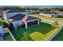 A well-manicured lawn and screened porch highlight this home's backyard at 2313 Ivy Harvest Pl, Oviedo, FL 32765