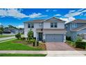 Charming two-story home with a two-car garage, brick paver driveway, and beautifully landscaped yard at 2313 Ivy Harvest Pl, Oviedo, FL 32765