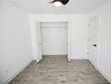 Neutral bedroom featuring wood-look tile flooring, a ceiling fan, and closet at 2360 Justy Way, Orlando, FL 32817