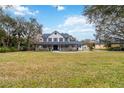 Beautiful two-story home with a spacious front yard, inviting porch, and traditional architectural details at 2365 Eagle Trace Dr, Kissimmee, FL 34746