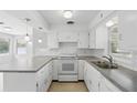 Bright kitchen featuring white cabinets, modern appliances, subway tile backsplash, and plenty of counter space at 2502 Falkner Rd, Orlando, FL 32810