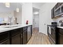 Well-lit kitchen with stainless steel appliances, sleek countertops, and modern fixtures at 2774 Almaton Loop # 403, Kissimmee, FL 34747
