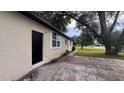 Single-story home featuring a side entrance, complemented by a well-maintained lawn and landscape at 3440 S Nashville Ave, Orlando, FL 32839