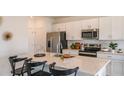 Modern kitchen features white cabinets, stainless steel appliances, and a spacious island with seating at 386 Wayland Dr, Haines City, FL 33844