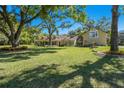 Charming single-Gathering home featuring a spacious lawn, mature trees, and lovely landscaping at 40600 Louise Rd, Umatilla, FL 32784