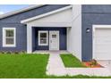 Close-up of the home's entrance, showing the front door and adjacent window at 4761 Sw 142Nd Place Rd, Ocala, FL 34473