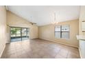 Bright living room features tile floors, a ceiling fan, and sliding glass doors at 605 Swallow Ct, Apopka, FL 32712