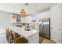 Bright kitchen features a large center island, stainless steel appliances, and modern pendant lighting at 705 Baffie Ave, Winter Park, FL 32789