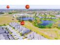 Aerial view of the townhome community near schools and a pond at 9743 Amber Chestnut Way, Winter Garden, FL 34787