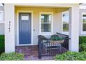 Inviting front porch with seating area and a neatly landscaped garden bed at 9743 Amber Chestnut Way, Winter Garden, FL 34787