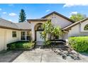 Inviting front entrance with double doors, arched entryway, lush landscaping, and clear house number at 10116 Pointview Ct, Orlando, FL 32836
