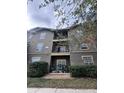 Multi-level condo building with balcony access and lush green landscaping at 102 Vista Verdi Cir # 220, Lake Mary, FL 32746