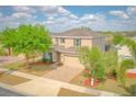Lovely home with a brick driveway, two-car garage and manicured lawn, perfect for Gathering living at 1040 Andalusia Loop, Davenport, FL 33837