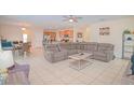 Spacious living room featuring tile flooring, modern decor, and an open concept layout at 1040 Andalusia Loop, Davenport, FL 33837