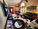 Spacious living room with vaulted ceiling, unique rug, and ample seating at 109 Lakepointe Cir, Kissimmee, FL 34743
