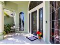 Inviting front porch featuring tile flooring, a seating area, and a decorative front door with sidelights at 11139 Crooked River Ct, Clermont, FL 34711