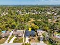 An aerial view showing the property, pool, neighborhood, and lush green landscaping at 116 E Cottesmore Cir, Longwood, FL 32779