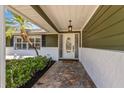 Welcoming front entrance with a stone pathway, decorative door, and well-maintained landscaping at 116 E Cottesmore Cir, Longwood, FL 32779