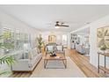 Bright living room featuring hardwood floors, large windows, and modern furnishings at 116 E Cottesmore Cir, Longwood, FL 32779