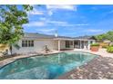 The refreshing backyard pool is surrounded by a brick paver deck, ideal for Florida outdoor living at 116 E Cottesmore Cir, Longwood, FL 32779