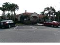 Community clubhouse featuring ample parking and mature landscaping, offering a great space to gather and socialize at 1285 S South Beach Circle Cir, Kissimmee, FL 34746