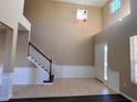 Bright foyer with high ceilings, decorative chandelier, staircase and elegant wainscoting detail at 13422 Exbury Ln, Windermere, FL 34786