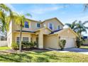 Beautiful two-story home with a well-kept lawn, professional landscaping, and a two-car garage at 14740 Hartford Run Dr, Orlando, FL 32828