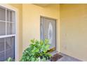Close up of front entrance with decorative glass door, welcome mat, and lush greenery at 14740 Hartford Run Dr, Orlando, FL 32828