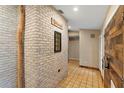 Inviting entryway with tiled flooring and a stylish brick accent wall with a 'Welcome' sign at 1475 Kettledrum Trl, Deltona, FL 32725