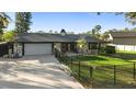 Charming exterior of a single-story home with an attached garage and a well-maintained front yard at 1475 Kettledrum Trl, Deltona, FL 32725