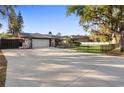 Wide driveway and fenced front yard on this home at 1475 Kettledrum Trl, Deltona, FL 32725