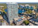 Beautiful aerial view of condo featuring a rooftop pool and tennis court overlooking the lake at 150 E Robinson St # 1007, Orlando, FL 32801