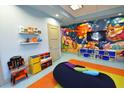 Vibrant playroom featuring colorful wall art, a TV, and -friendly furniture at 1551 Observer Ln, Davenport, FL 33896